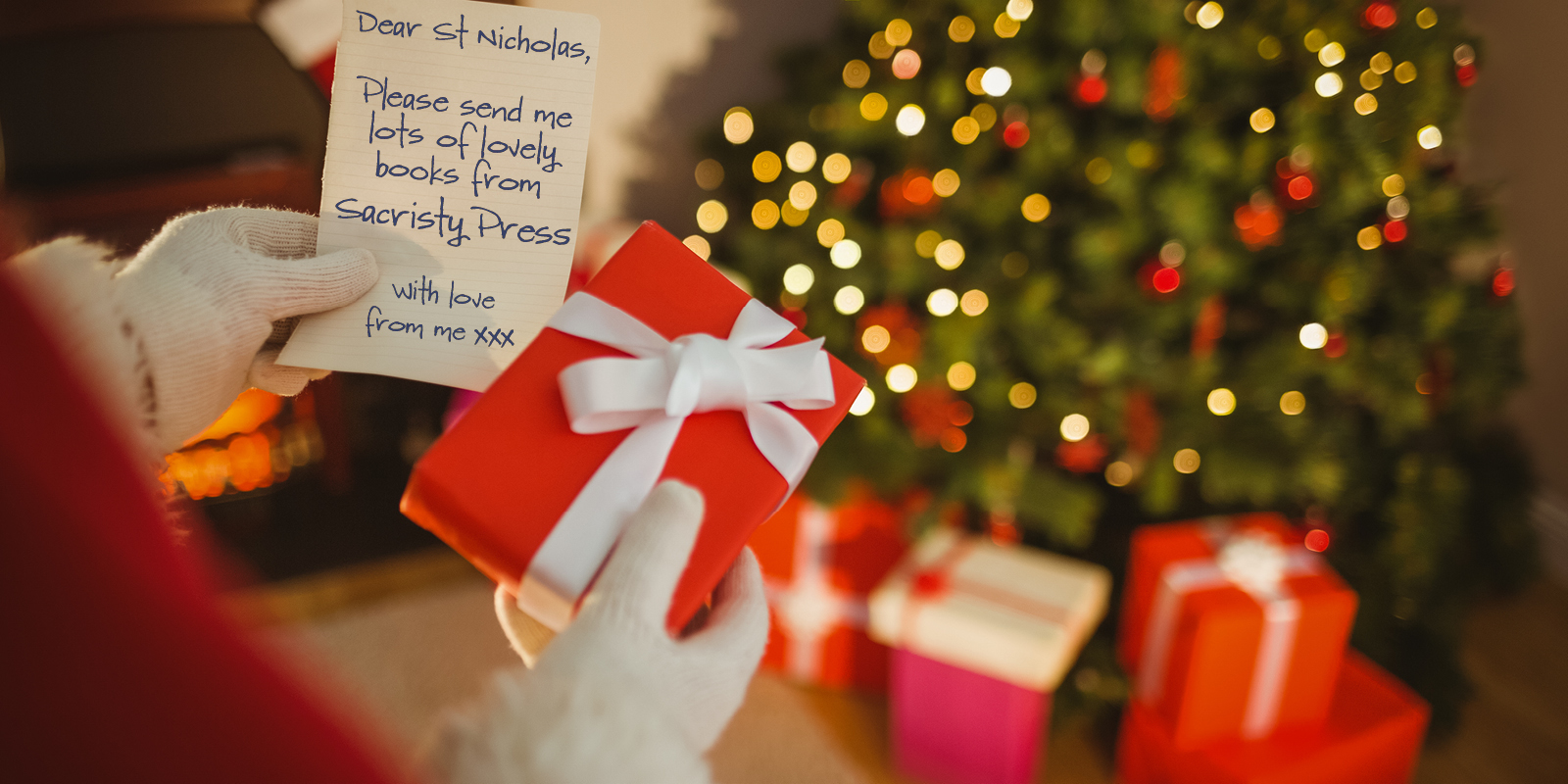 Photograph of St Nicholas putting gifts under a Christmas tree